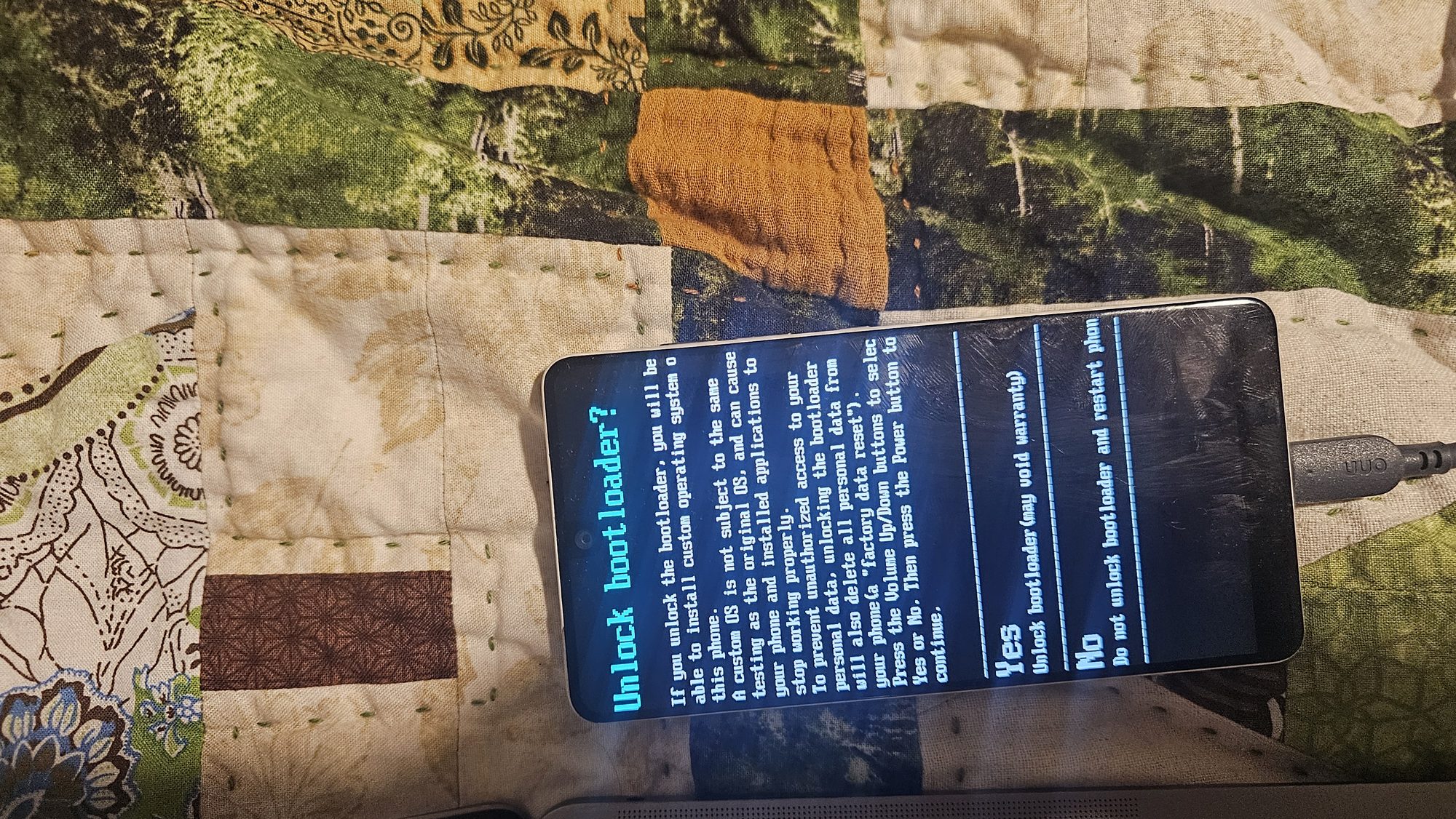 Close-up of the Essential Phone's "Unlock bootloader?" warning screen with Yes and No options